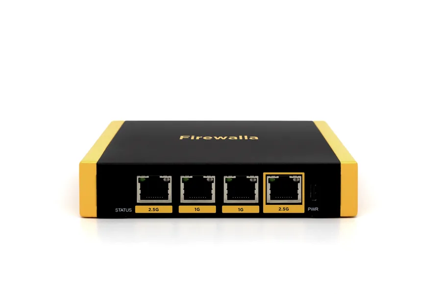 Firewalla Gold SE network security device, a small black and yellow box with four Ethernet ports